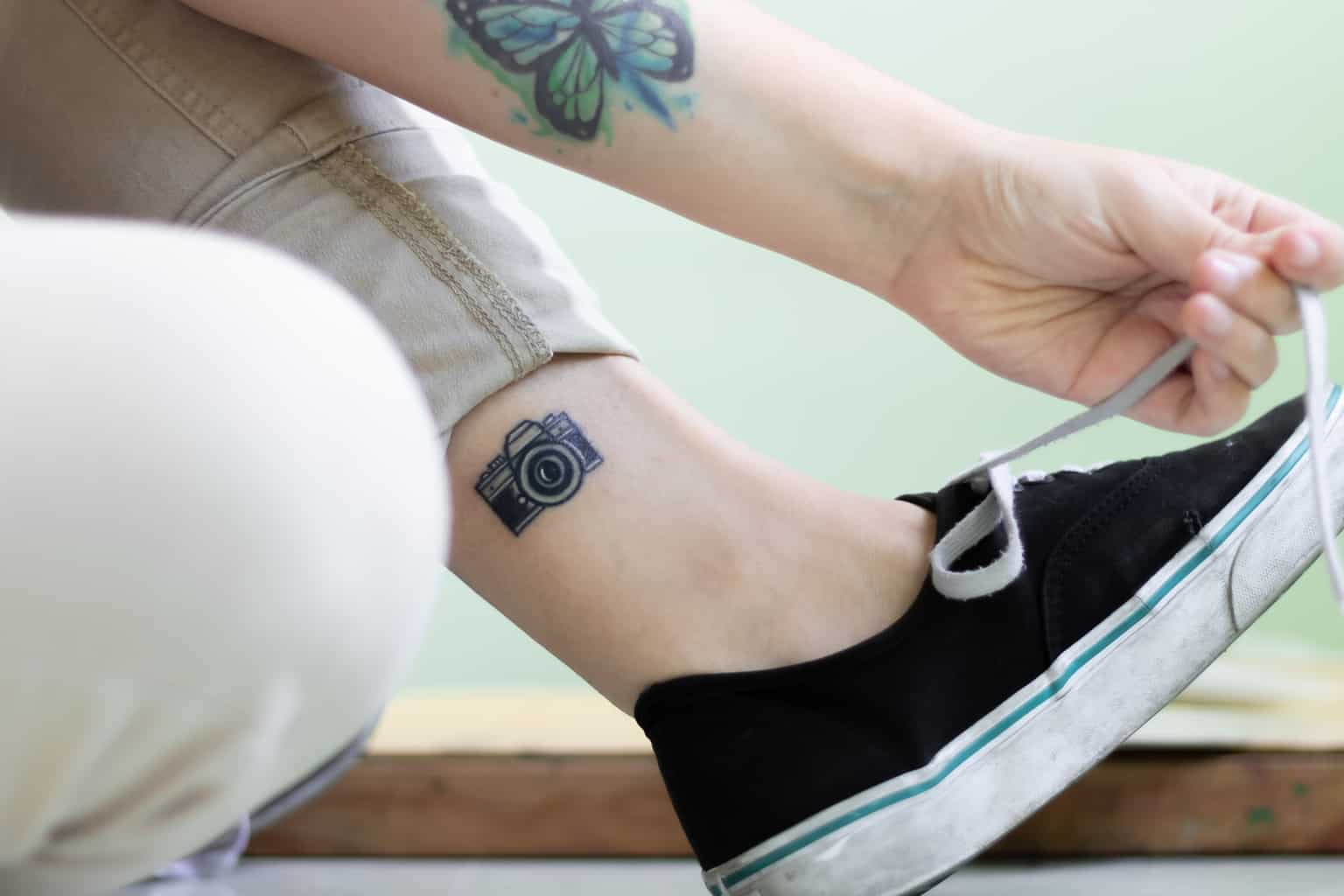 Black Micro Camera Ankle Tattoo | selftattoo.com