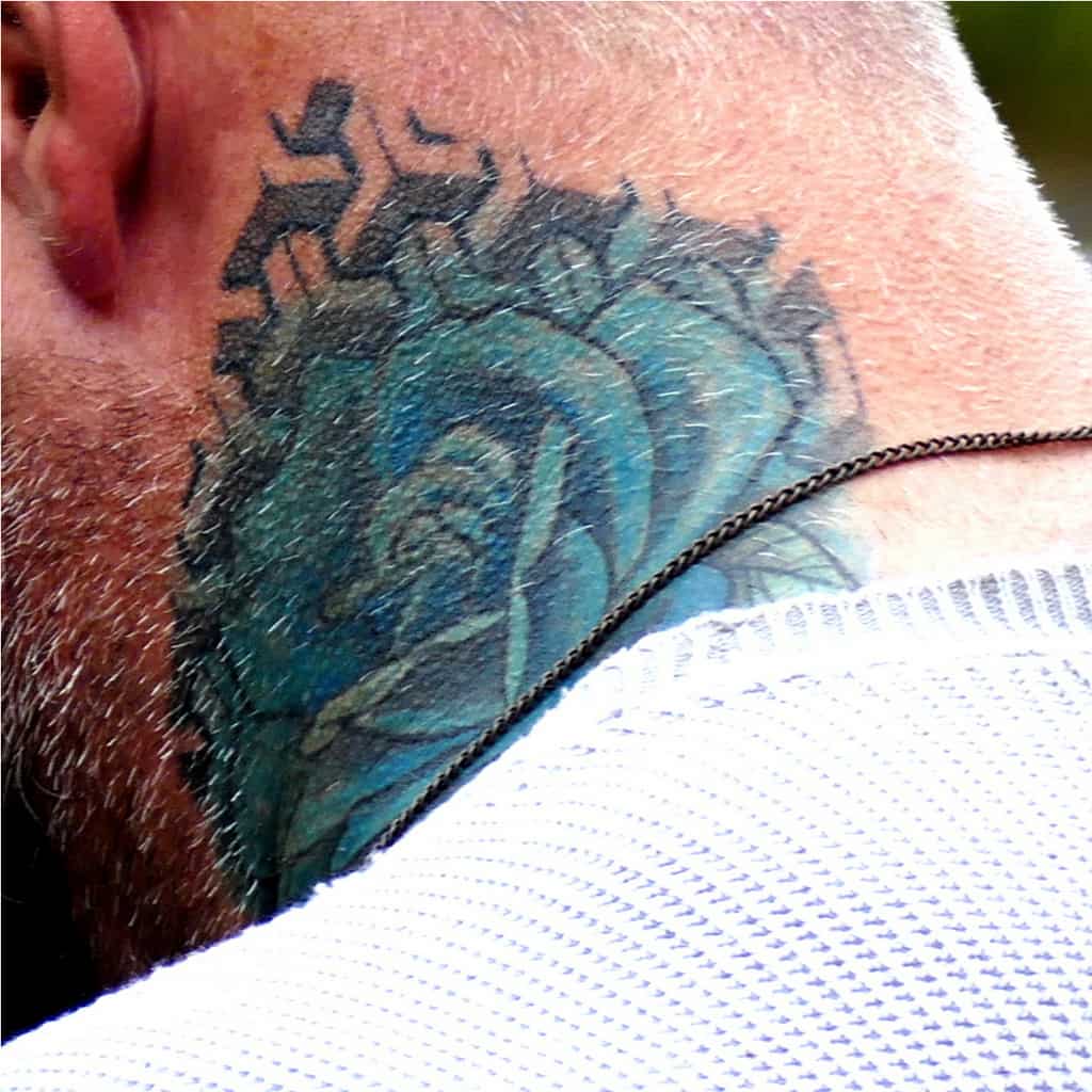 Realistic Blue Rose surrounded by Geometric Patterns Side of Neck Tattoo | selftattoo.com