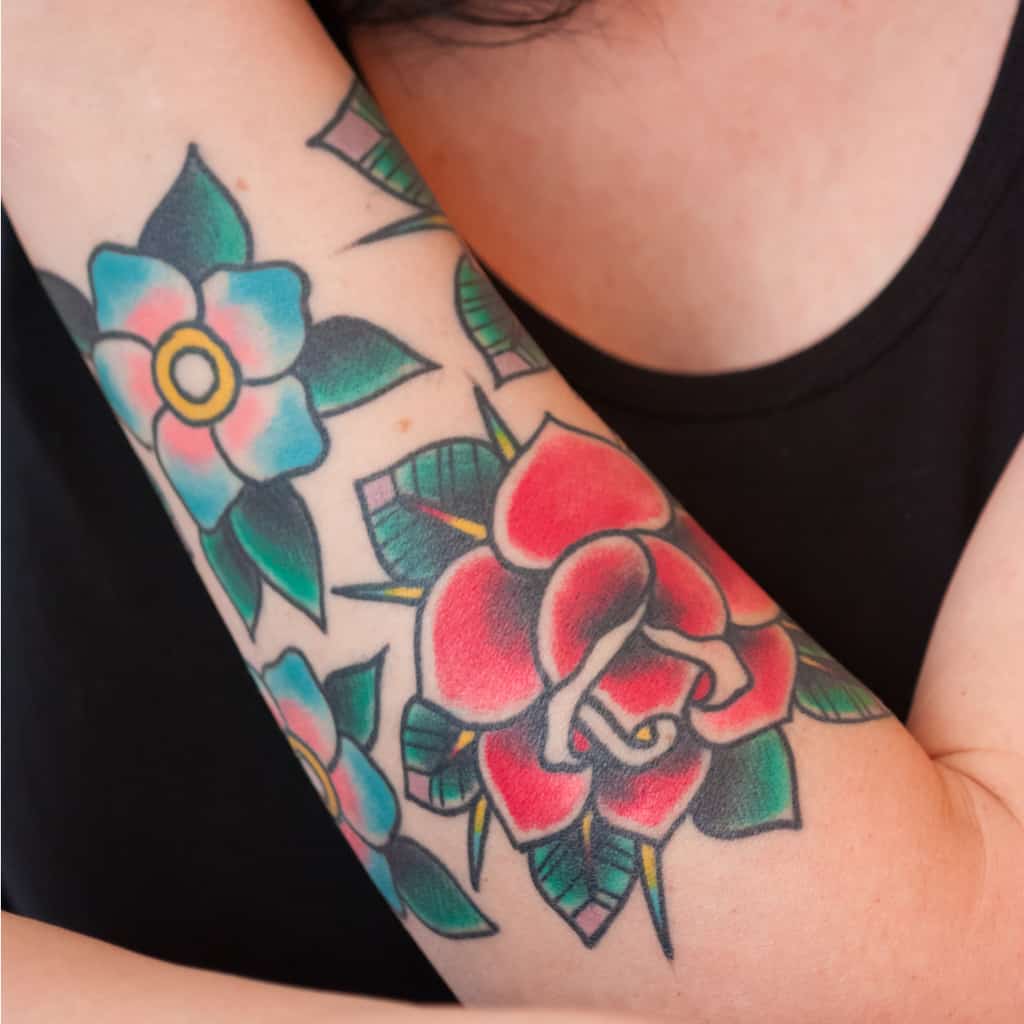 Bold Traditional Style Red and Blue Roses with Thick Black Outlines Forearm Tattoo | selftattoo.com