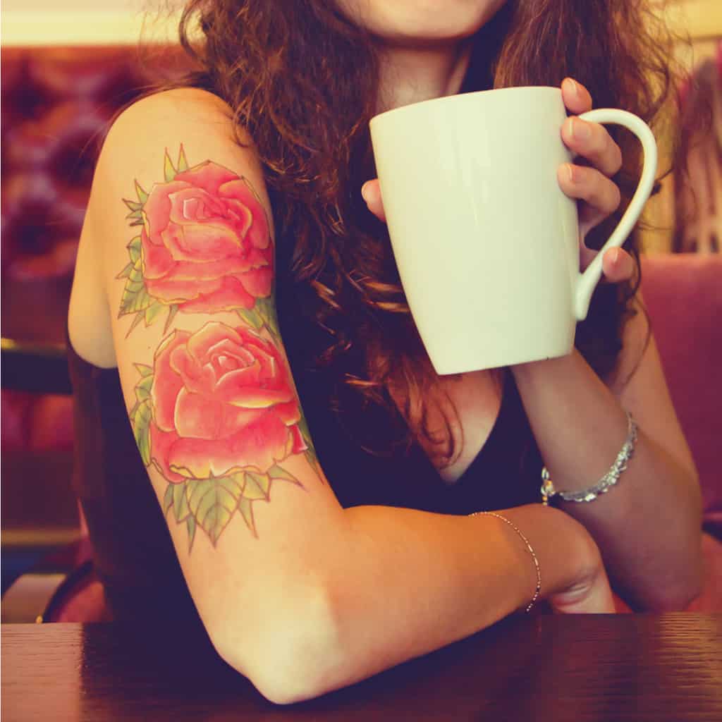 Two Large Red Roses with Soft Shading and Overlapping Petals Upper Arm Tattoo | selftattoo.com