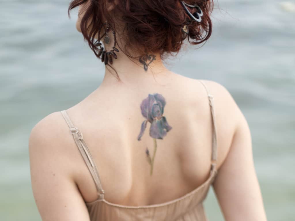 Single Realistic Purple Iris Flower with Long Green Stem Upper Back Tattoo | selftattoo.com