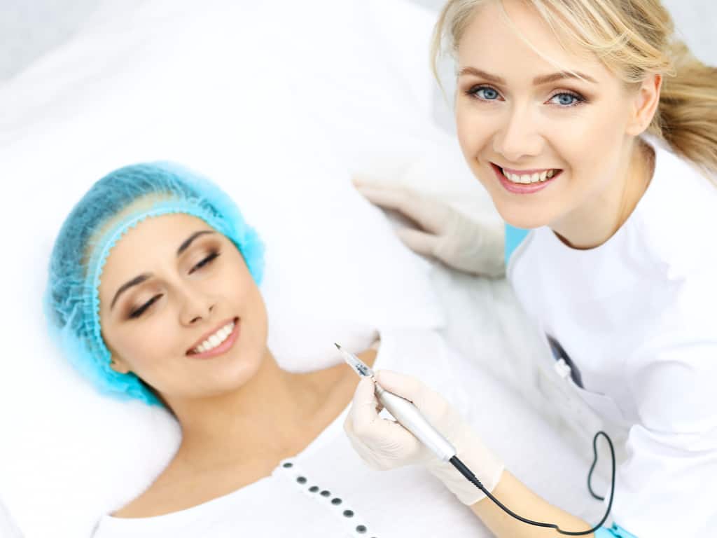 Woman laying down in a Cosmetic Clinic about to undergo a Cosmetic Procedure | selftattoo.com