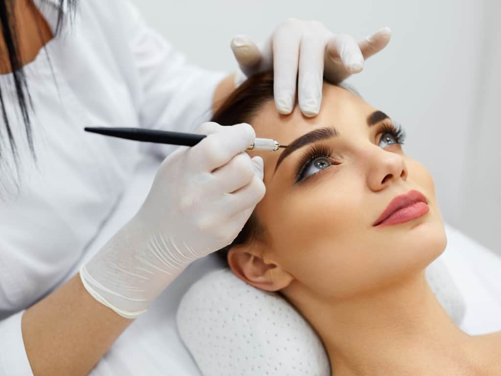 Woman undergoing Eyebrow Tattooing Procedure known as Microblading | selftattoo.com