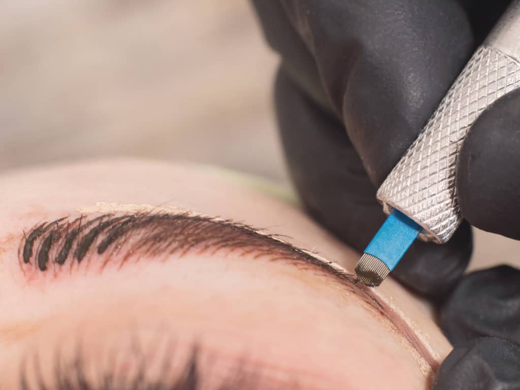 Close-up of a Microblading Tool making Small Fine Strokes along the Eyebrow | selftattoo.com