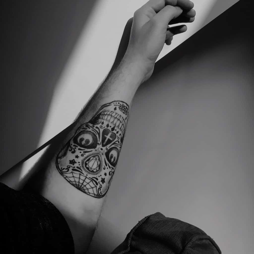 Large Detailed Black and Gray Sugar Skull With Stars and Decorative Patterns Forearm Tattoo | selftattoo.com