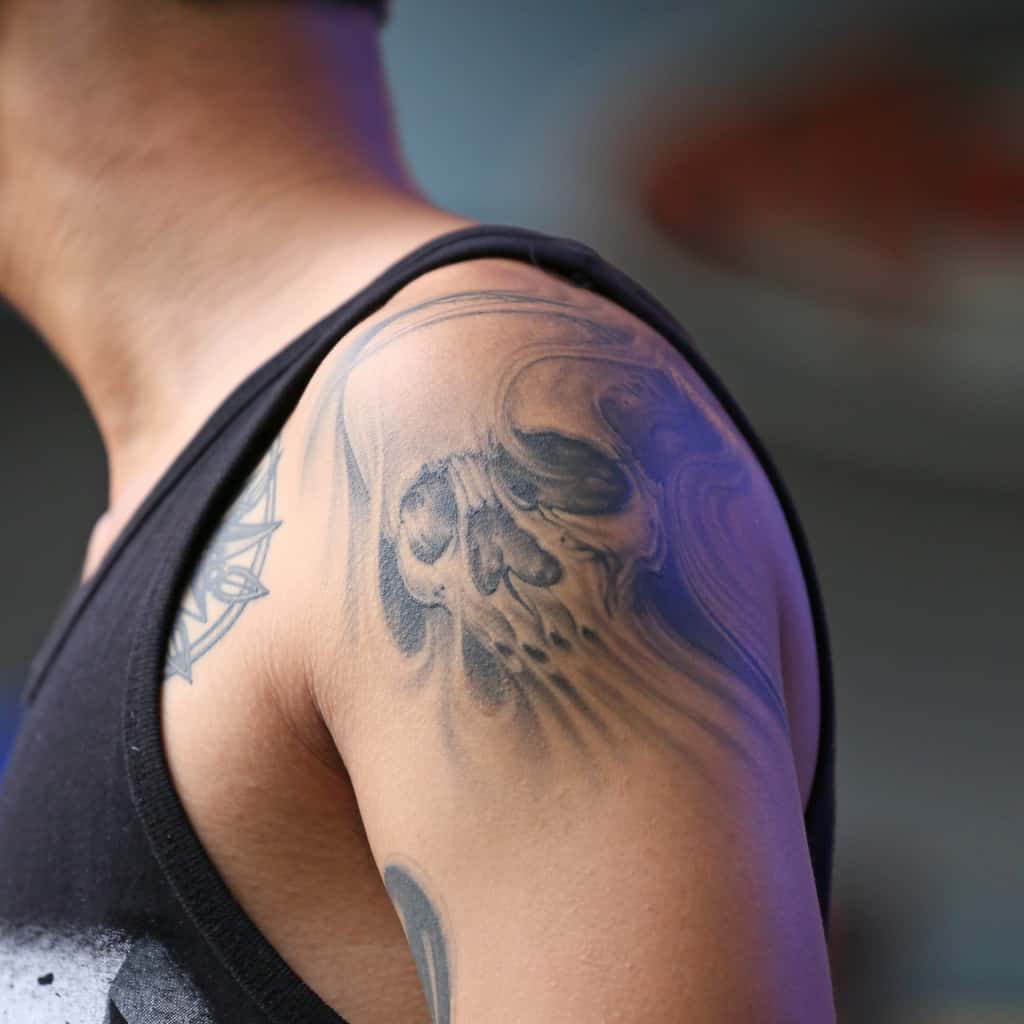 Realistic Black and Gray Skull with a Ghostly appearance Shoulder Tattoo | selftattoo.com