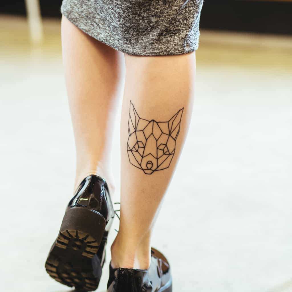 Geometric Minimalist Wolf Head Calf Tattoo | selftattoo.com