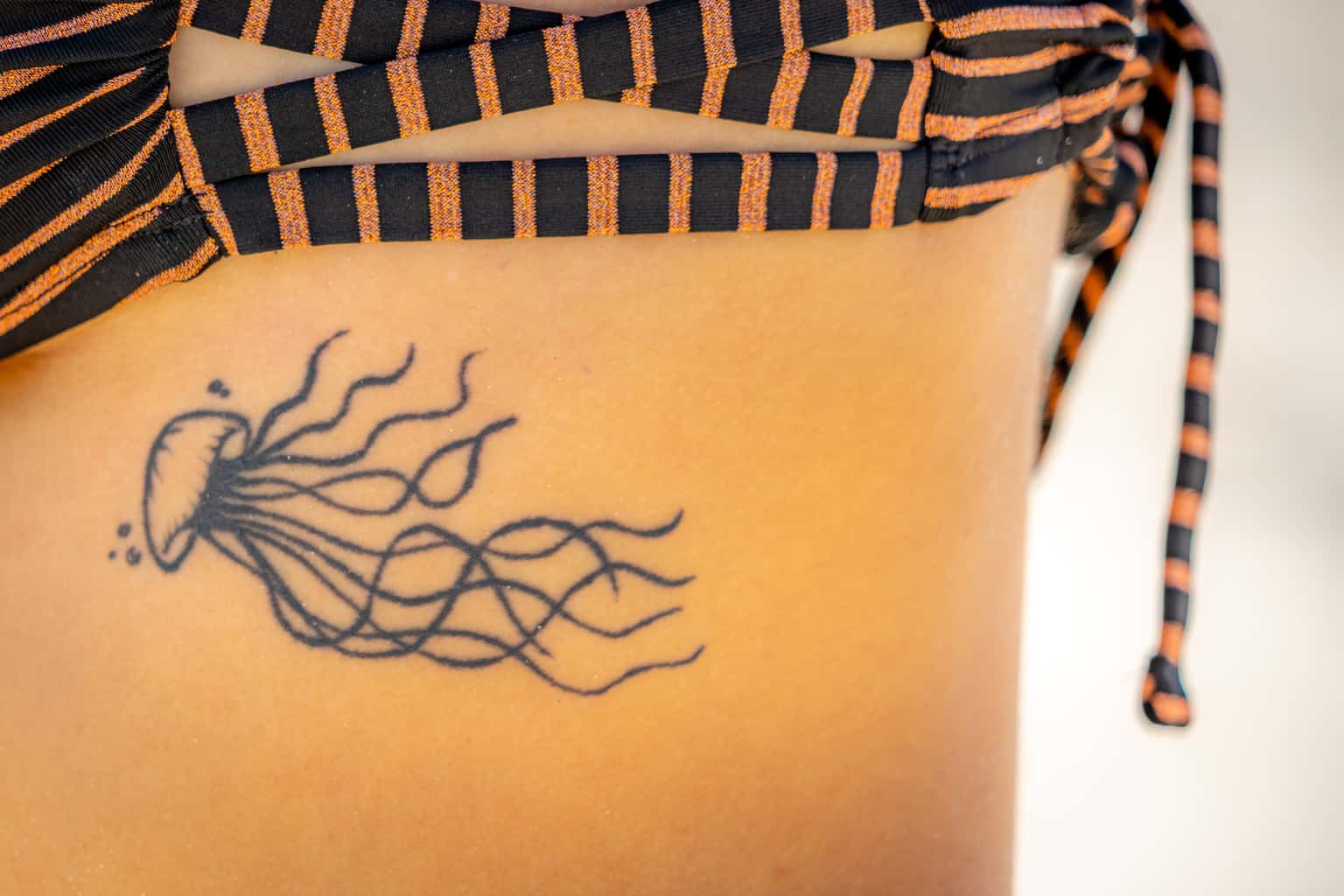 Small Simple Minimalistic Jellyfish Tattoo with Long Flowing Tentacles | selftattoo.com