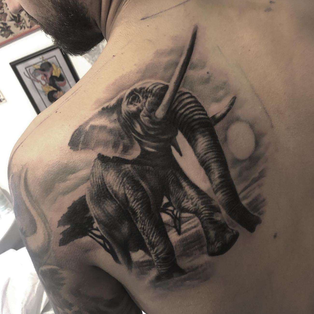 Realistic Black and Gray Elephant in an African Landscape Shoulder Blade Tattoo | selftattoo.com