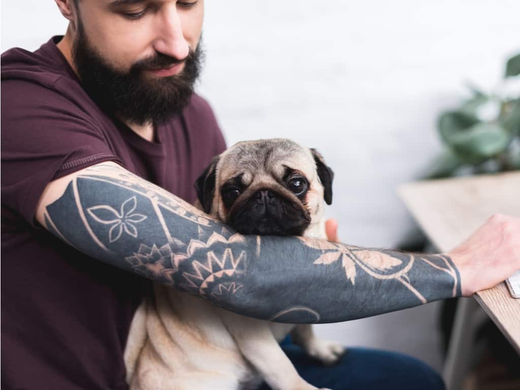 Solid Black Negative Space Sleeve Tattoo featuring Geometric and Botanical Motifs | selftattoo.com