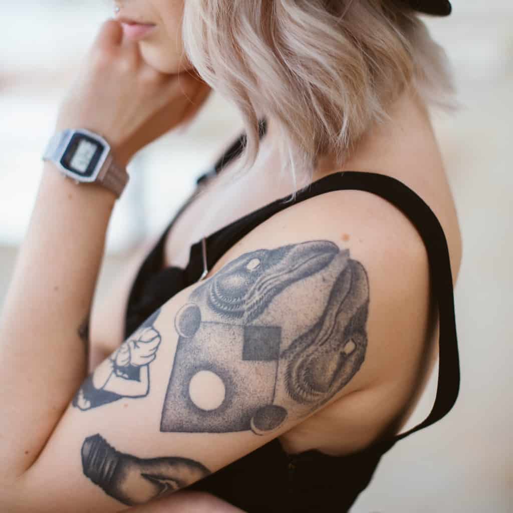 Black and Gray Abstract Style with Dotwork of Two Bird Heads with Geometric Shapes Arm Tattoo | selftattoo.com