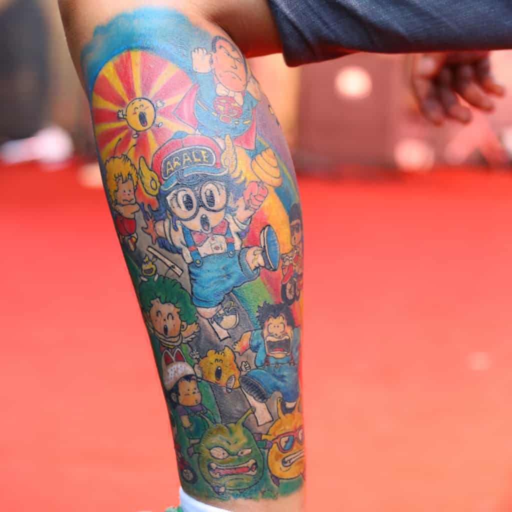 Japanese Pop Culture Style Lower Leg Tattoo of Vibrant and Playful Anime Characters | selftattoo.com