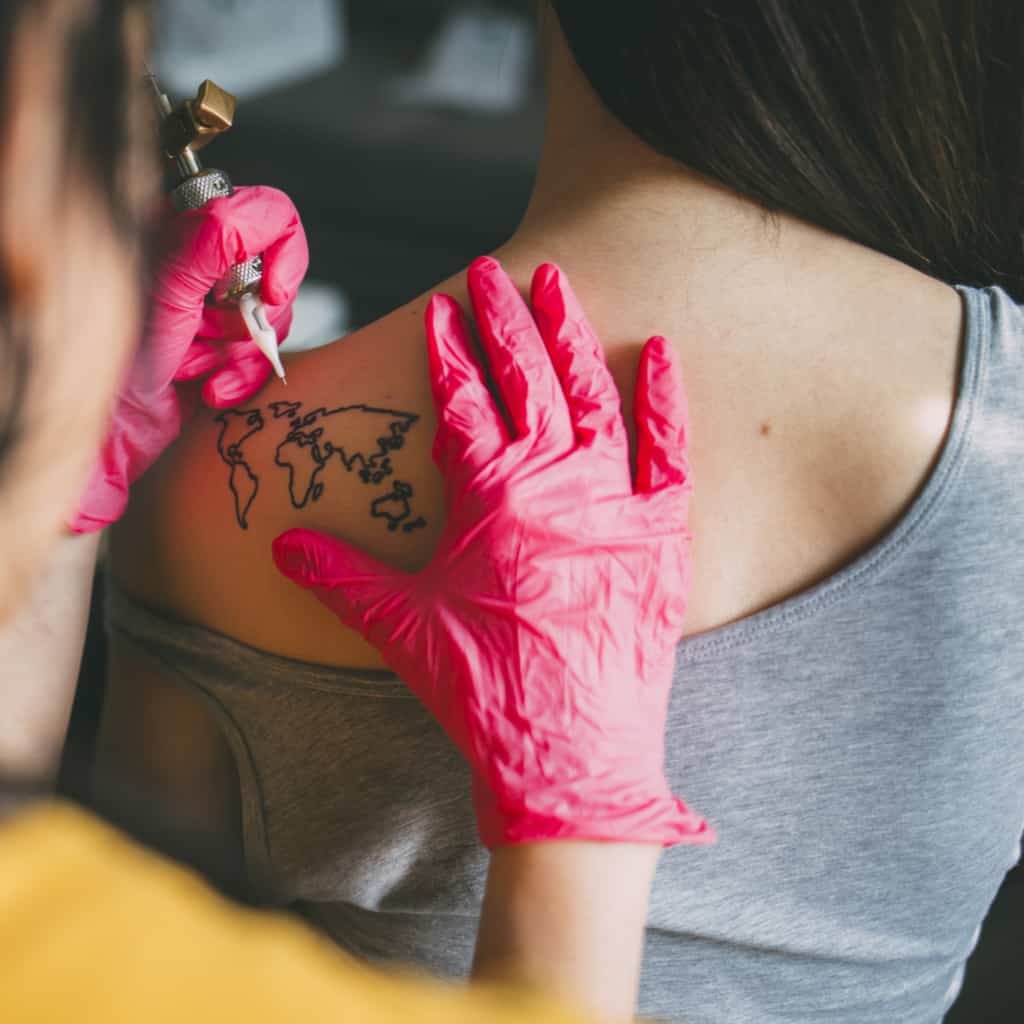 Simple Minimalist Black Outline of the World Map Shoulder Blade Tattoo | selftattoo.com