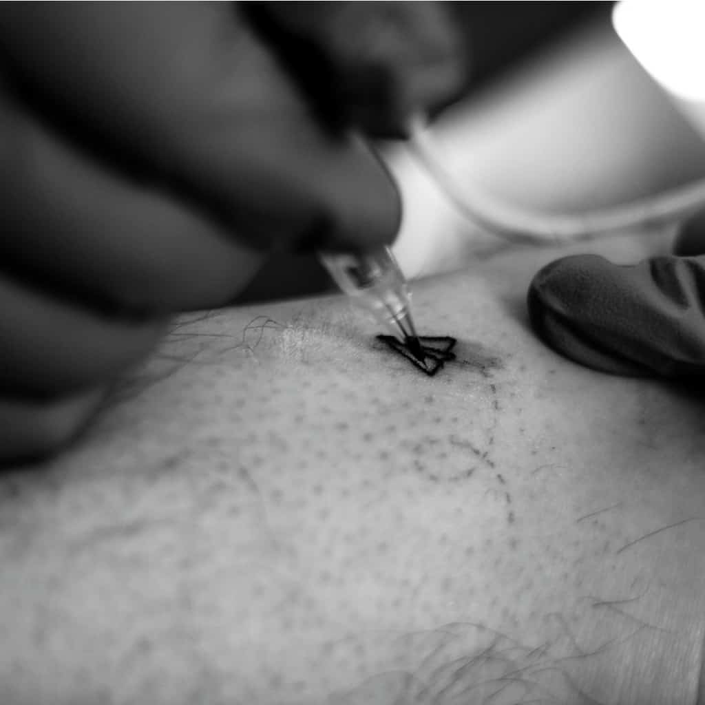 Small Simple Black Outline of a Paper Airplane Tattoo with a Trail of Dashed Lines | selftattoo.com