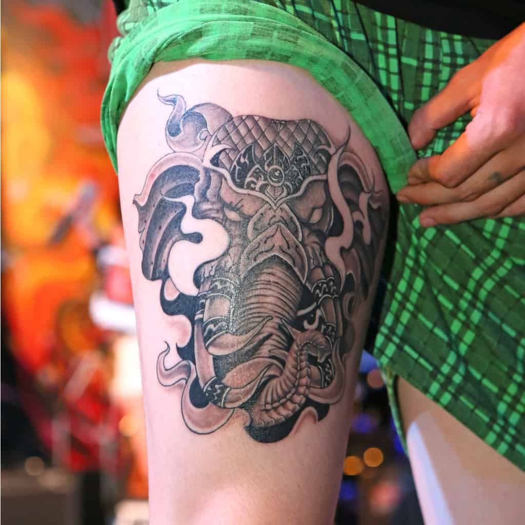 Bold Black and Gray War Elephant's Head with a Fierce and Powerful Appearance Thigh Tattoo | selftattoo.com