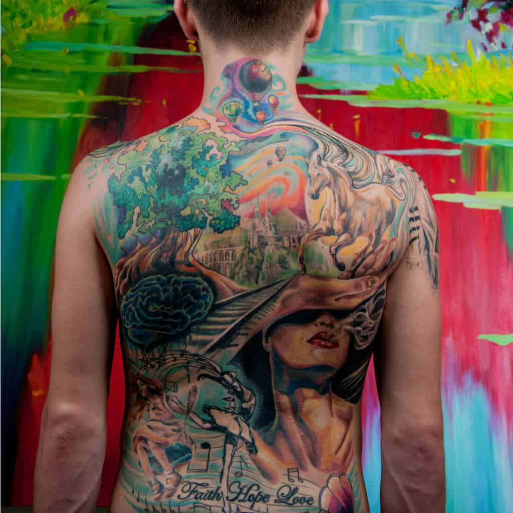 Colorful Surrealism Style Full Back Tattoo featuring a Mix of Nature and Human Figures | selftattoo.com