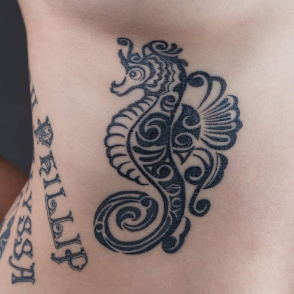 Solid Black Tribal Style Seahorse Tattoo filled with Swirling Patterns | selftattoo.com