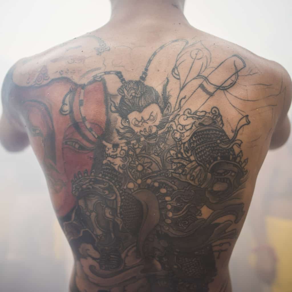 Bold Black and Gray Mythological Warrior Figure Back Tattoo inspired by Chinese/Japanese Folklore | selftattoo.com