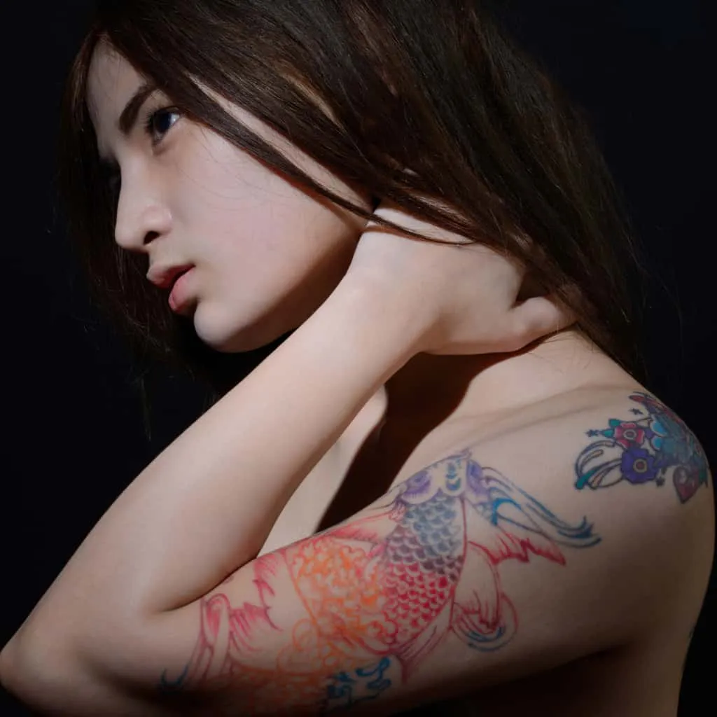 Multicolor Linework of a Koi Fish Upper Arm Tattoo | selftattoo.com