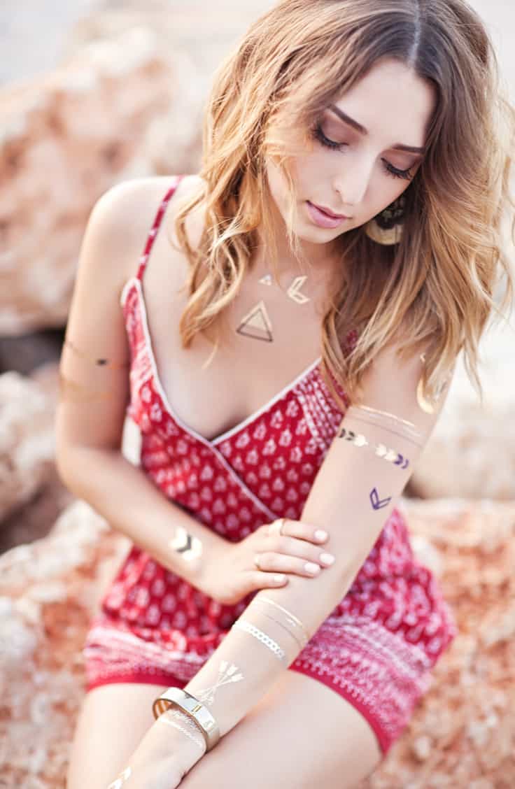 Woman wearing a Red Dress adored with several Metallic Armbands and Arrows Temporary Tattoos | selftattoo.com