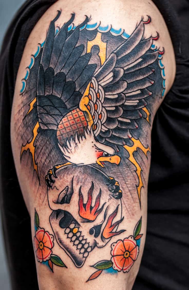 Bold and Colorful Traditional American Style Tattoo featuring an Eagle carrying a Skull | selftattoo.com