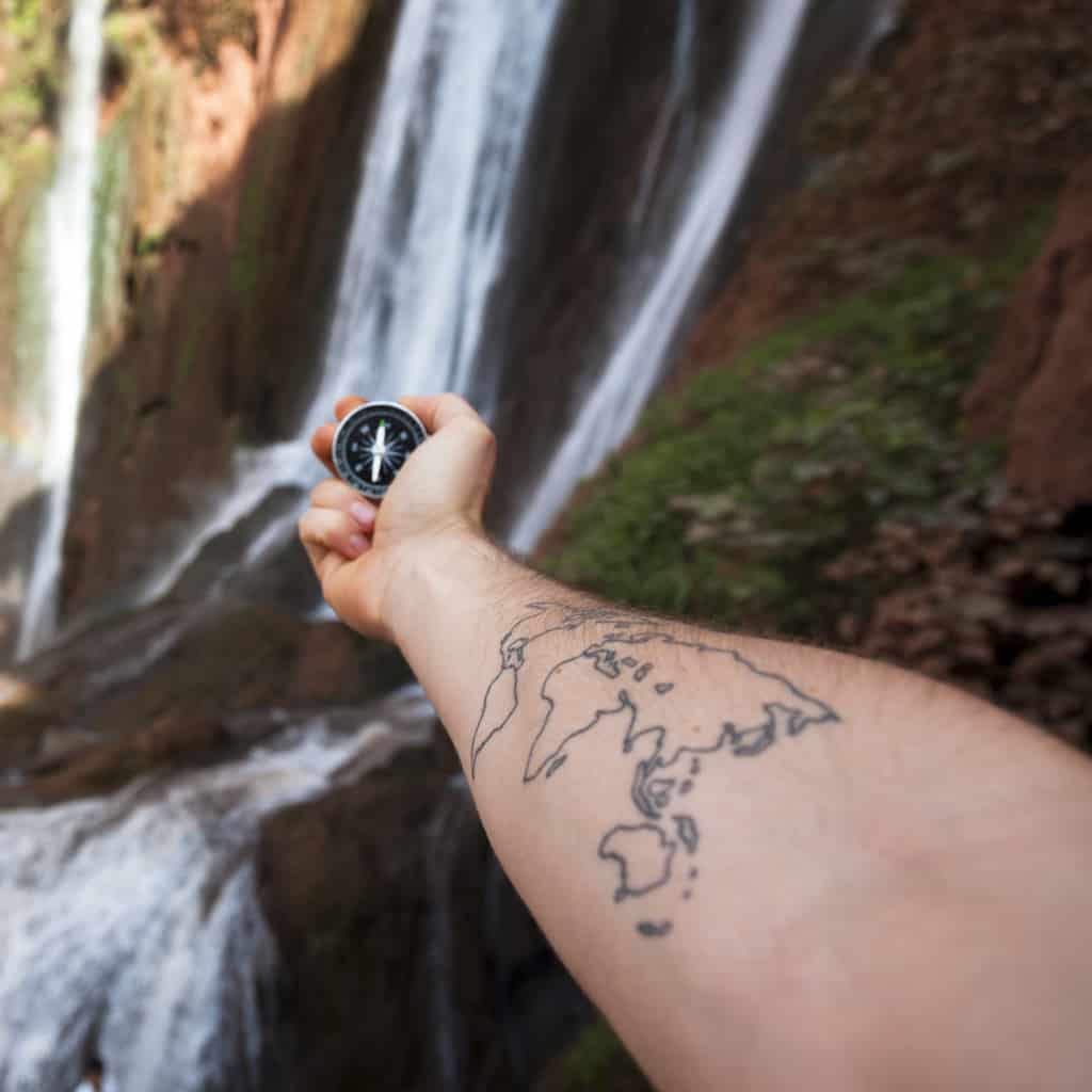 Simple Minimalist Black Outline of the World Map Forearm Tattoo | selftattoo.com