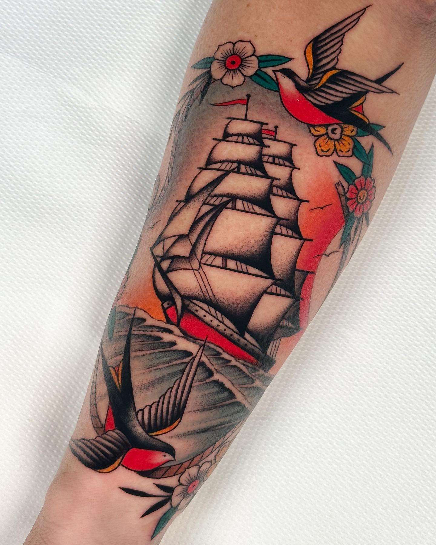 Classic American Traditional Style Ship Tattoo with Swallows and Flowers | selftattoo.com