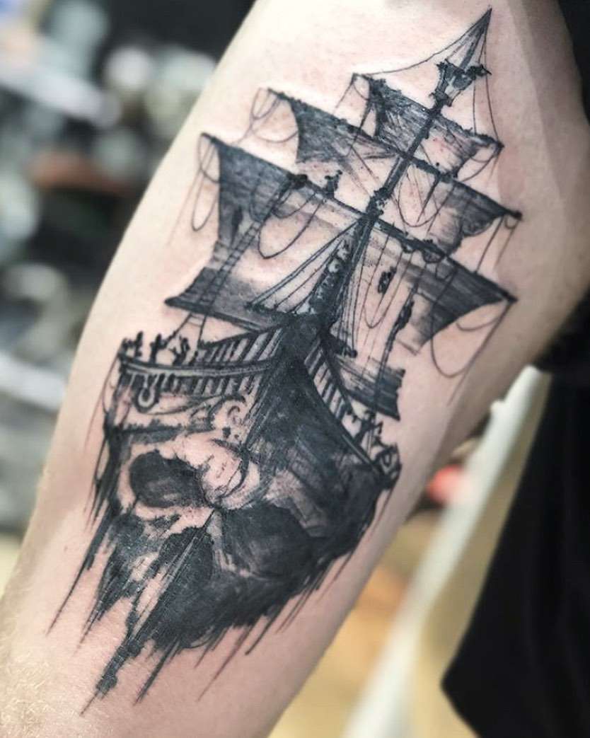 Realistic Black and Gray Ghost Ship Tattoo with a Skull blended into the Base | selftattoo.com