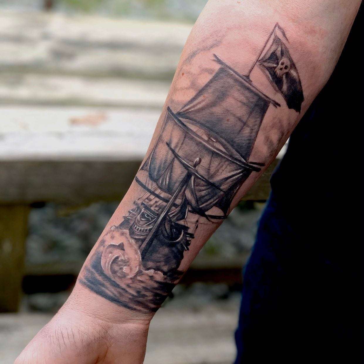 Realistic Black and Gray Pirate Ship Tattoo with a Pirate Flag featuring a Skull/Crossbones | selftattoo.com