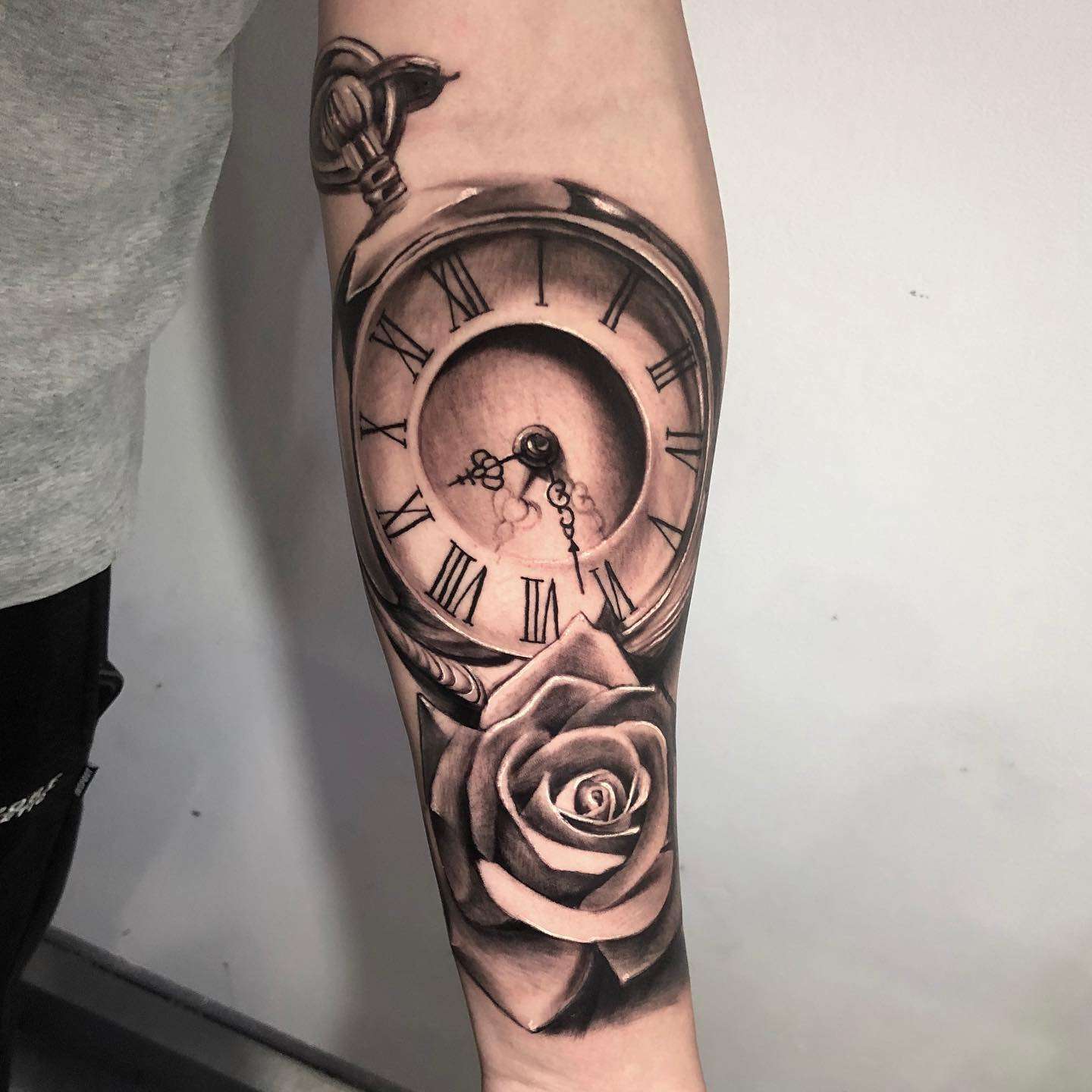 Large Hyper Realistic Black and Gray Pocket Watch Forearm Tattoo with a Rose | selftattoo.com