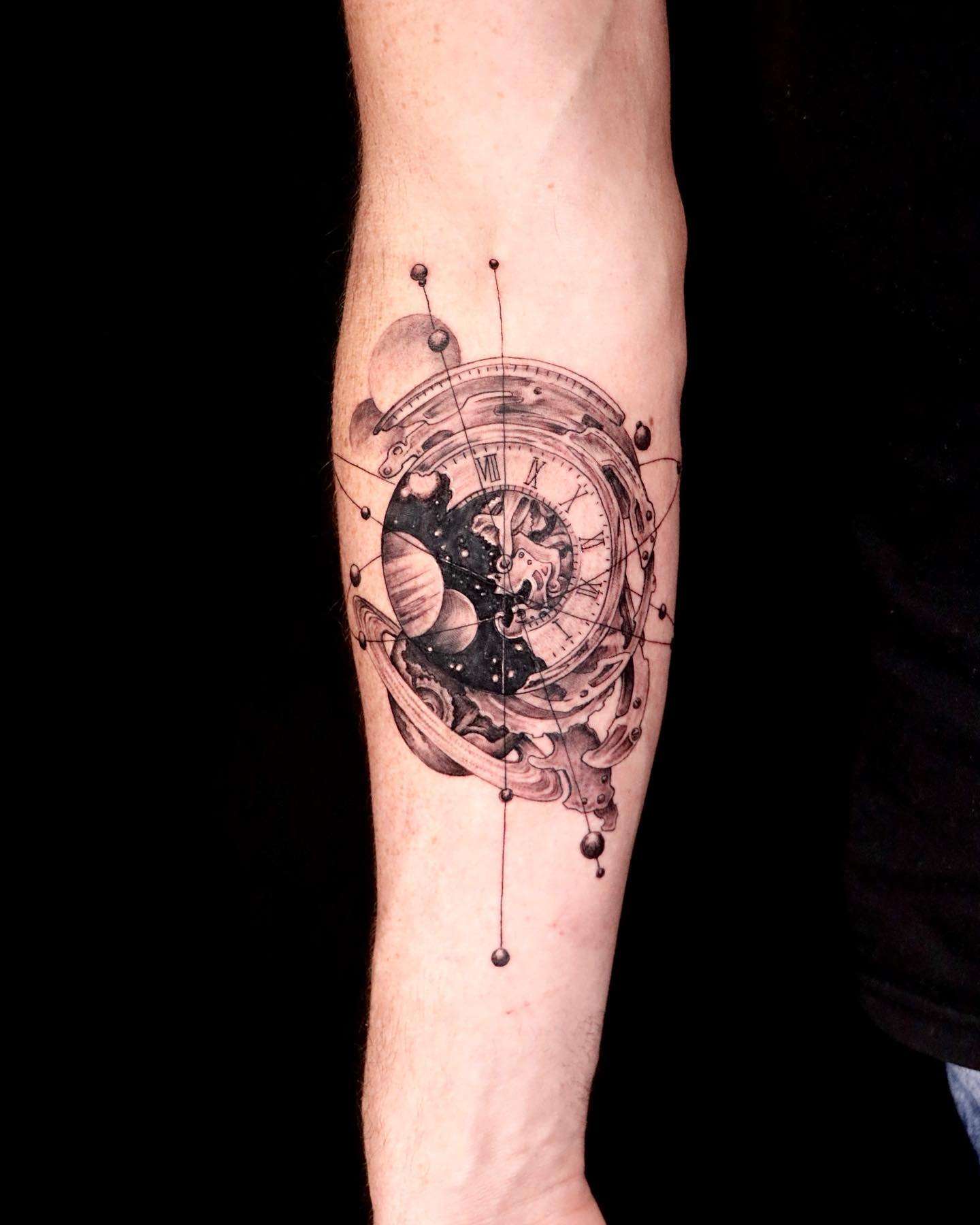 Realistic Monochrome Time and Space Forearm Tattoo | selftattoo.com