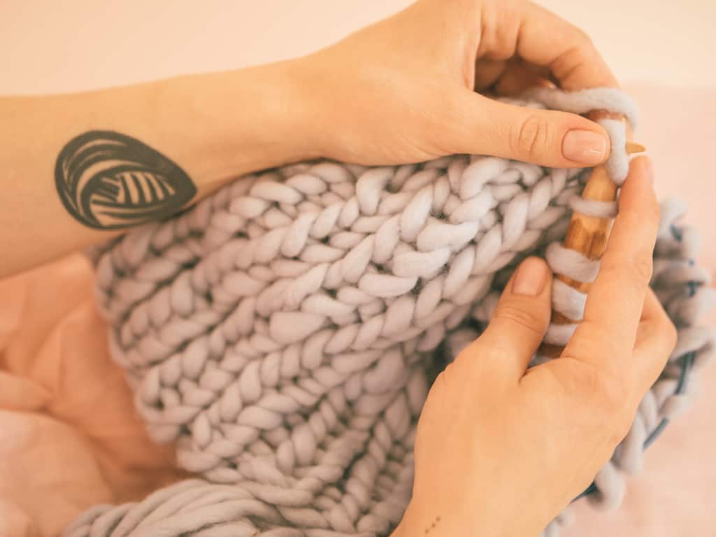 Bold Solid Black Linework of a Ball of Yarn Forearm Tattoo | selftattoo.com