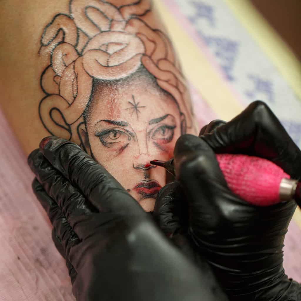 Close-Up of a Medusa Face Tattoo with Bold and Fine Black Linework | selftattoo.com