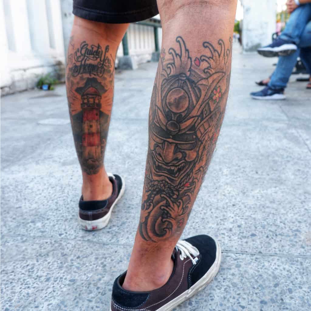 Lighthouse and Samurai Mask Calf Tattoos | selftattoo.com