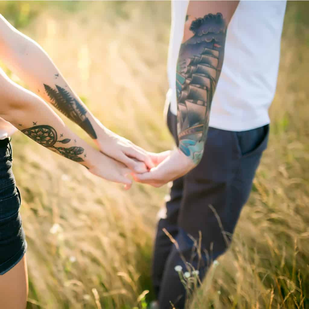 Bold and Colorful Traditional Tall Ship Forearm Tattoo within an Ocean Setting | selftattoo.com