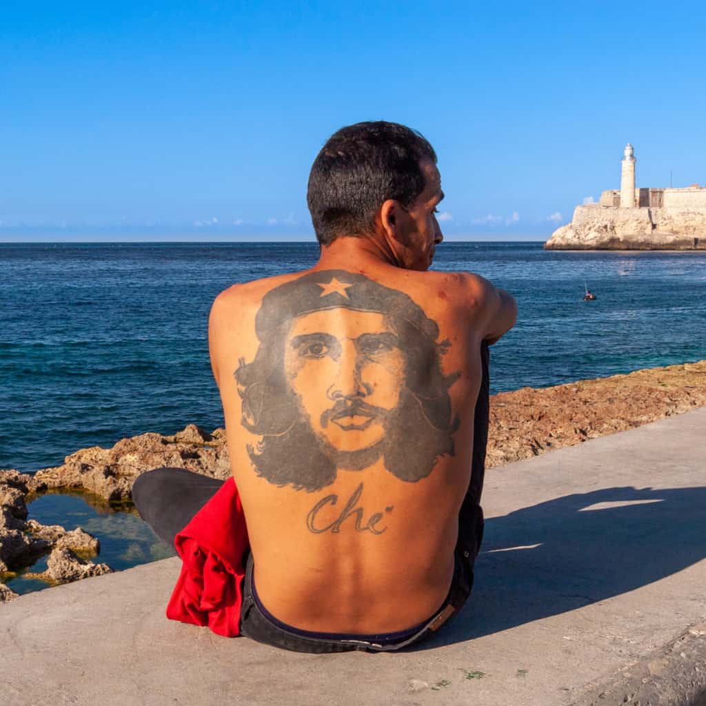 Large Solid Black Portrait of Che Guevara wearing a Beret with a Star and the Name "Che" Back Tattoo | selftattoo.com