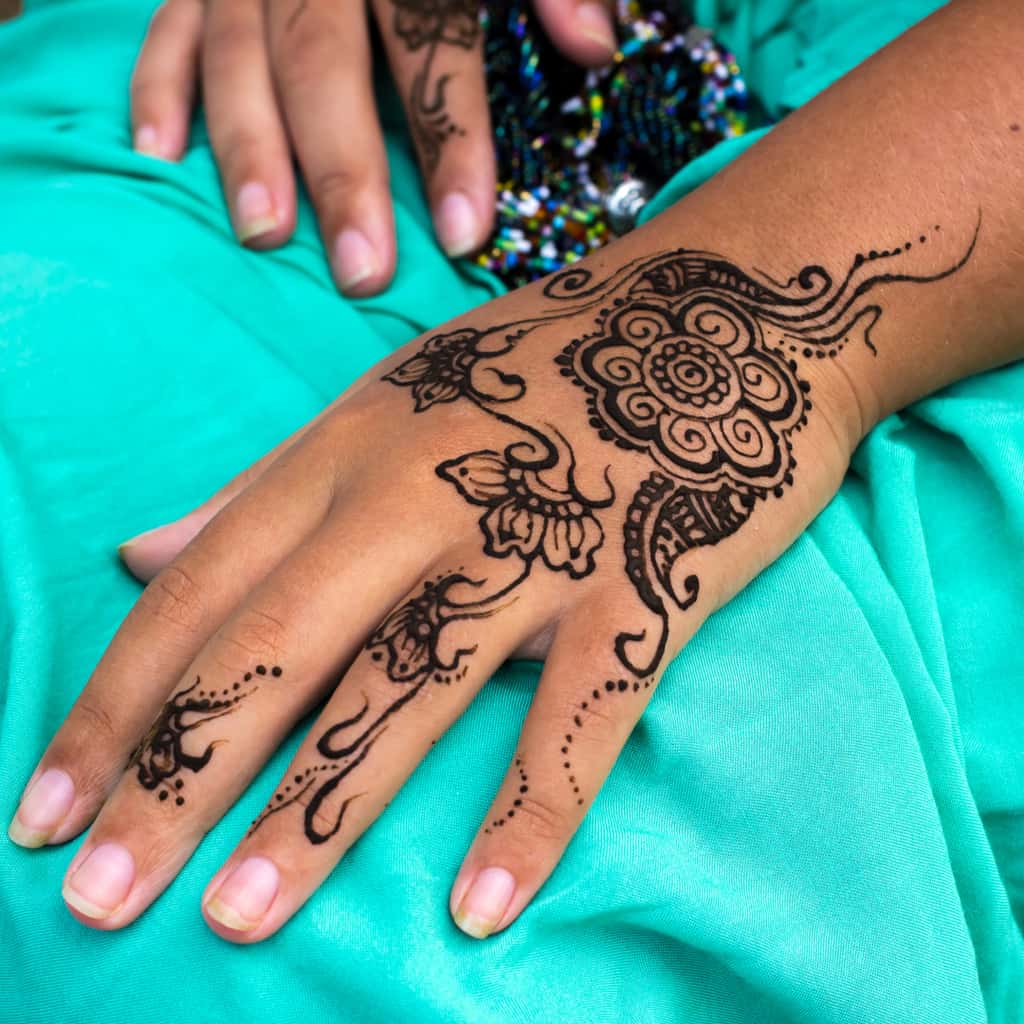 Beautiful Flower and Swirling Patterns Hand and Finger Jagua Tattoo | selftattoo.com