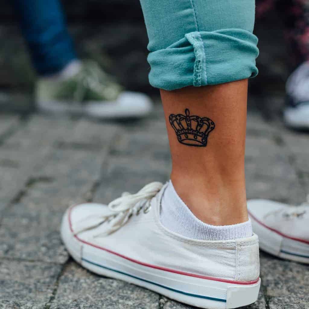 Simple Black Outlined Crown Tattoo on Outer Ankle | selftattoo.com