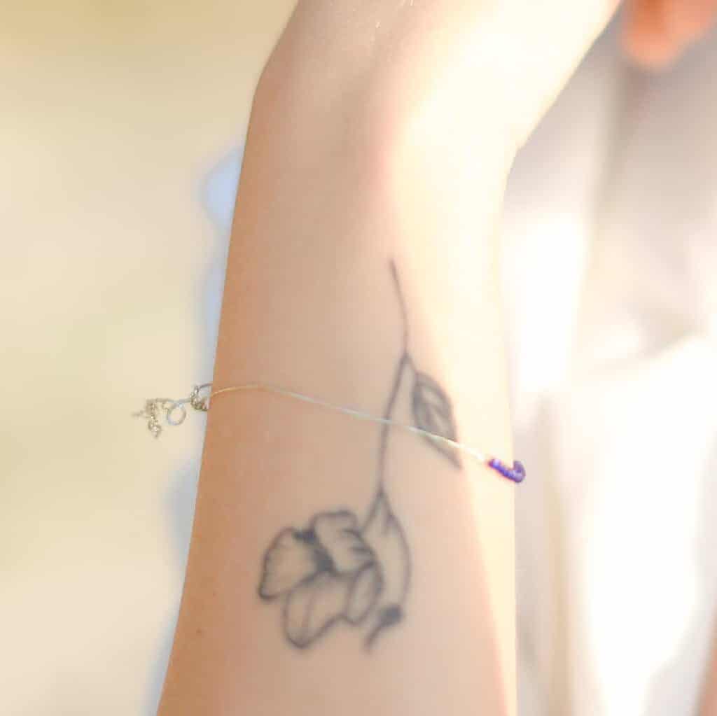 Delicate Fine Line Flower Forearm Tattoo | selftattoo.com