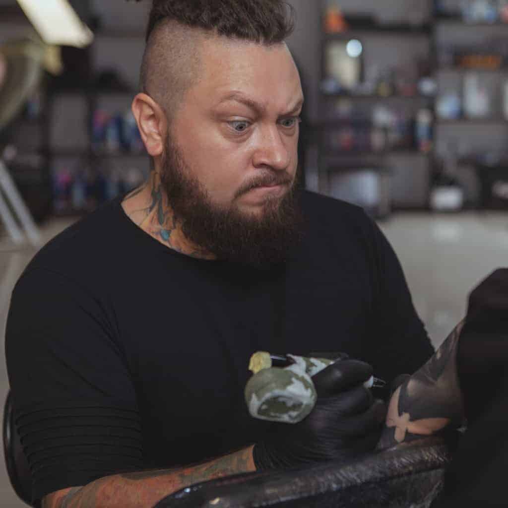 Tattoo Artist with Neck and Forearm Tattoos | selftattoo.com