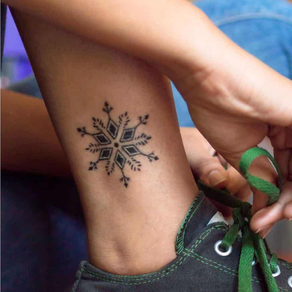 Delicate Structure of a Snowflake Ankle Tattoo | selftattoo.com