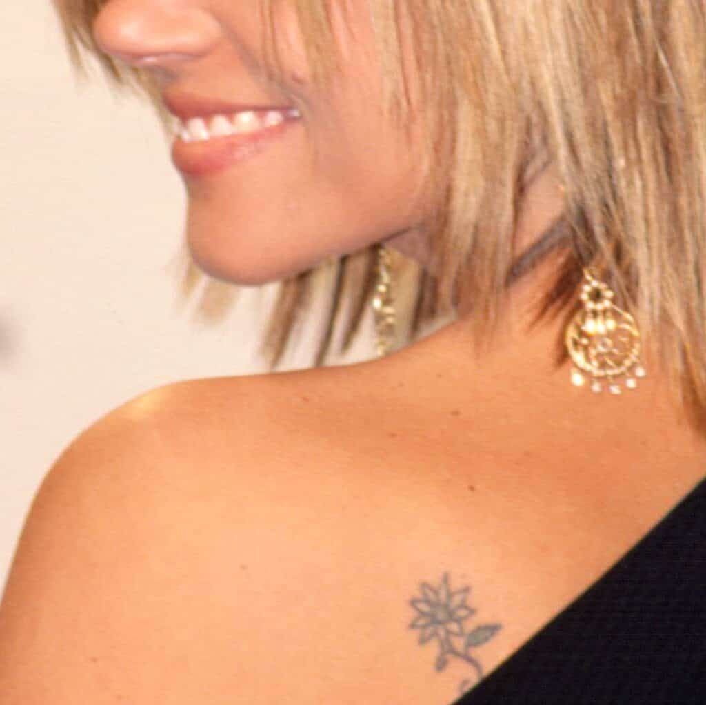 Small and Delicate Flower Tattoo on Shoulder Blade | selftattoo.com