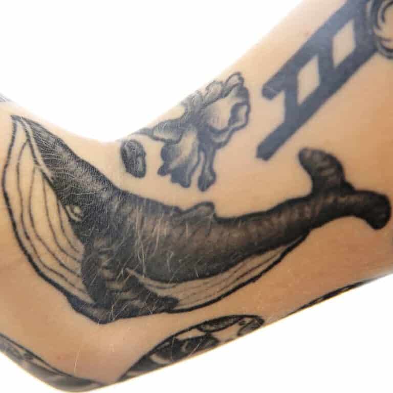 Solid Black and Gray Whale with Bold Outlines Arm Tattoo | selftattoo.com