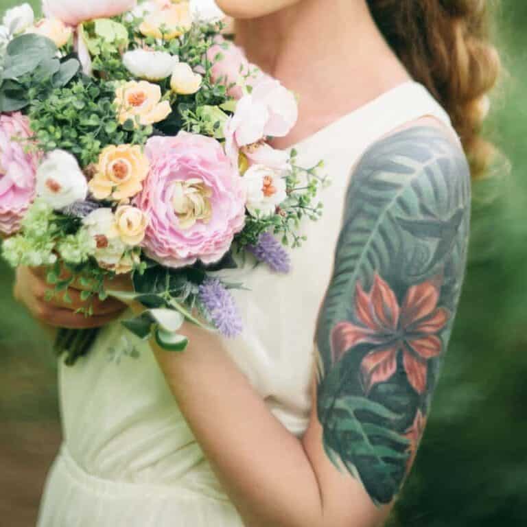 Large Realistic Tropical Foliage with a Prominent Red Hibiscus Upper Arm Tattoo | selftattoo.com