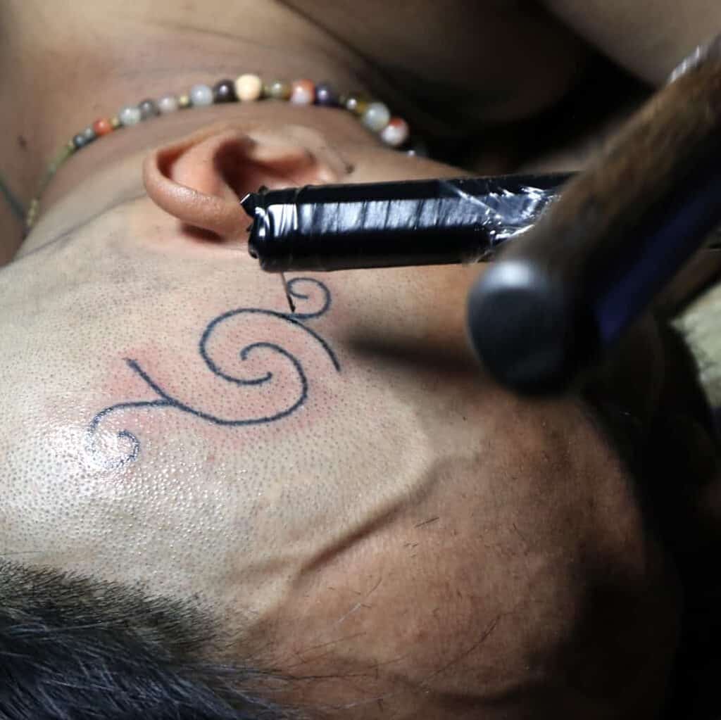 'Tatatau' Minimalistic Curving Lines Side of Head Tattoo | selftattoo.com