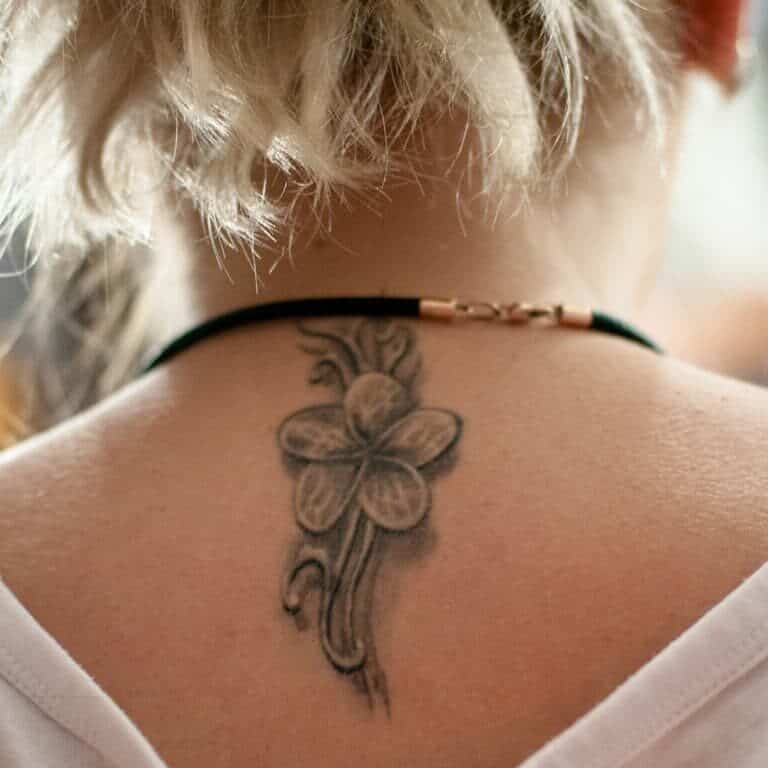 Single Elegant Black and Gray Flower with Five Petals Upper Back Tattoo | selftattoo.com