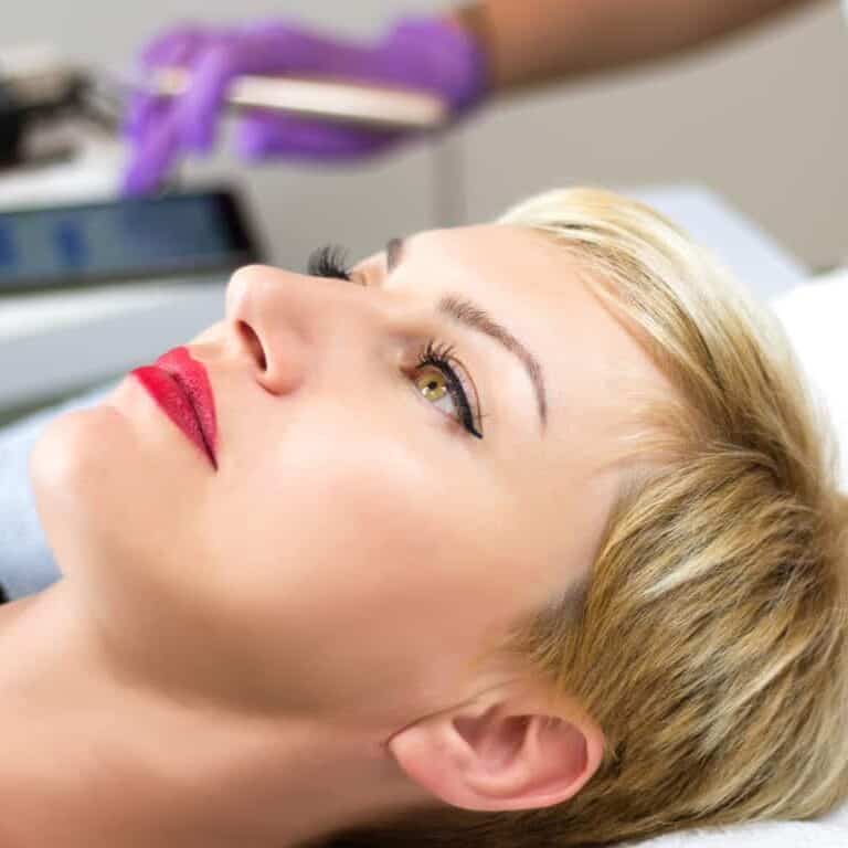 Woman laying down after an Eyeliner Tattooing Procedure | selftattoo.com