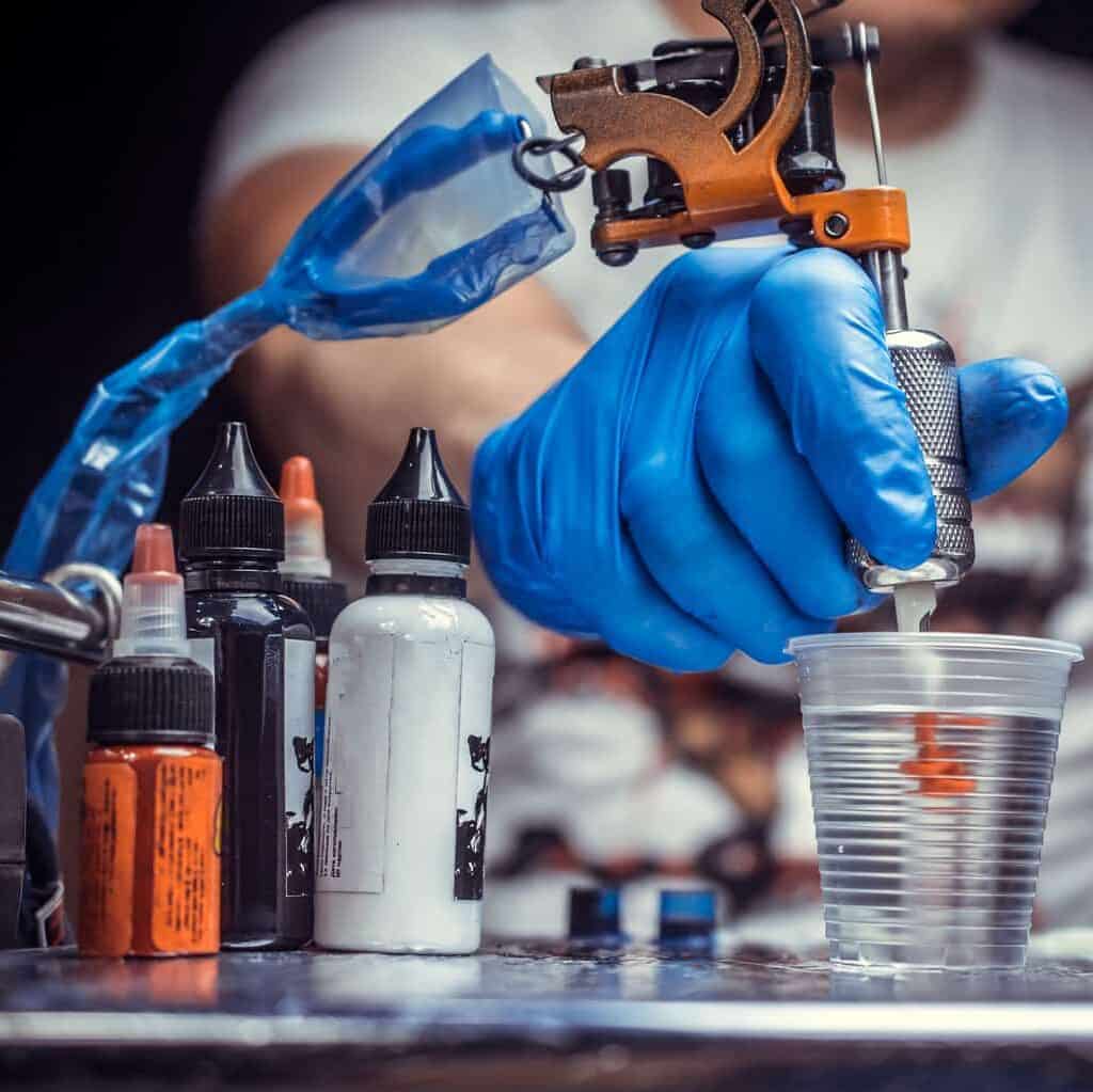 Close-Up of a Tattoo Artist holding a Tattoo Machine | selftattoo.com