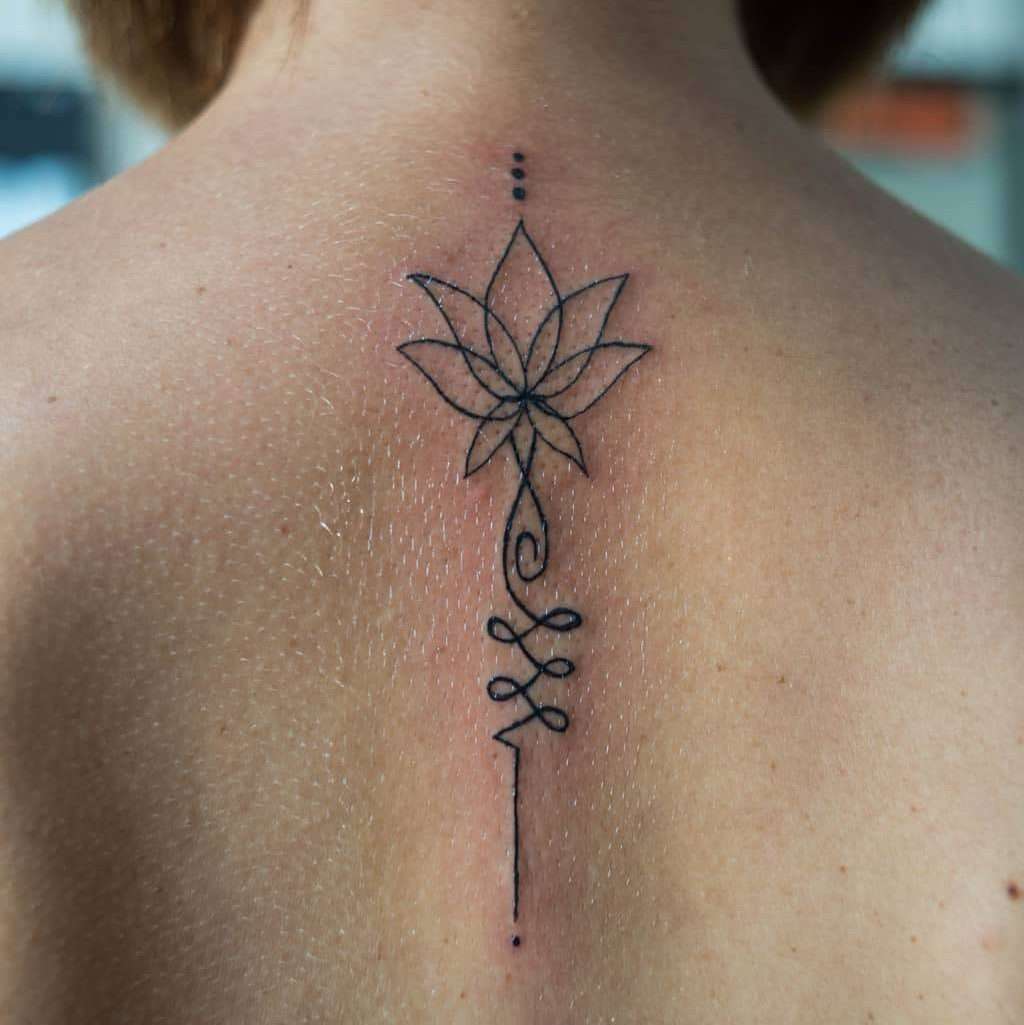 Delicate Minimalist Lotus Flower Back Tattoo | selftattoo.com